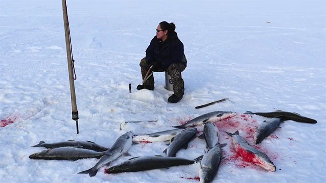 Xyler's mom Stephanie ice fishing in Kotzebue